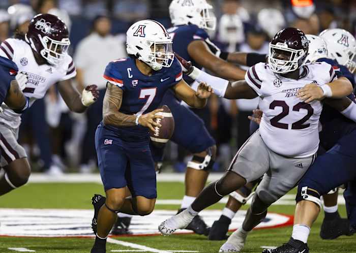 Sep 10, 2022; Tucson, Arizona, USA; Arizona Wildcats quarterback Jayden de Laura (7) against Mississippi State Bulldogs defensive tackle Nathan Pickering (22) at Arizona Stadium. Mandatory Credit: Mark J. Rebilas-USA TODAY Sports  